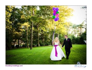 bride and groom with colorful balloons