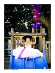 bride and groom on playground slide