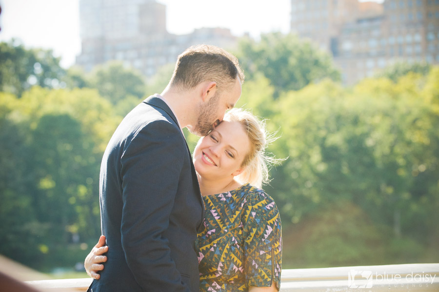 newly engaged couple on Bow Bridge in Central Park NYC