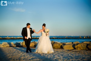 bride and groom walking in the sand