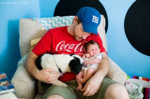 newborn baby with daddy and dog