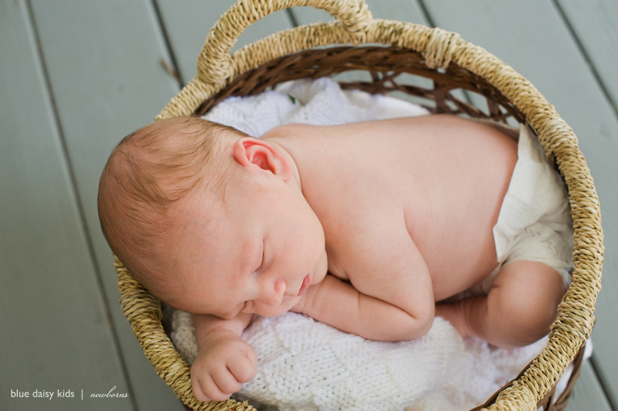 baby boy sleeping in a basket