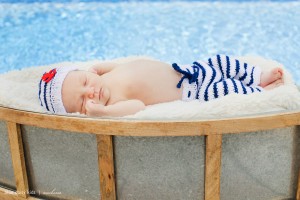 newborn baby boy in sailor outfit with boat