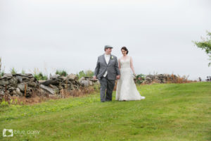 bride and groom walking in the field