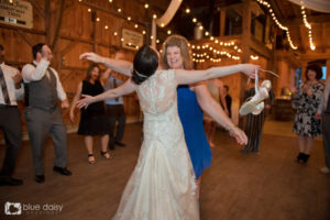 bride dancing with guests barefoot